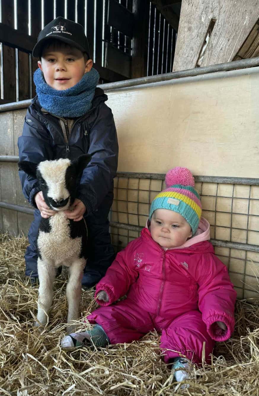 E:\Users\Clive\Downloads\Grace and Gordon Connor with a lamb at the Dun-mor flock.jpg